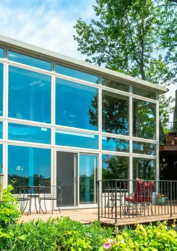 Insulated sunroom at a Manitoba lake cottage in fall.